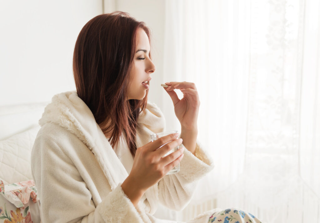 Get the most suitable weed detox products on online Ill woman holding a glass of water, taking pills